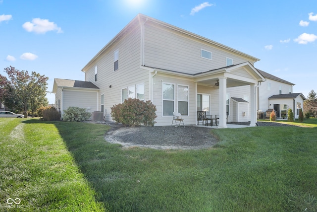 back of house with a patio, ceiling fan, and a yard