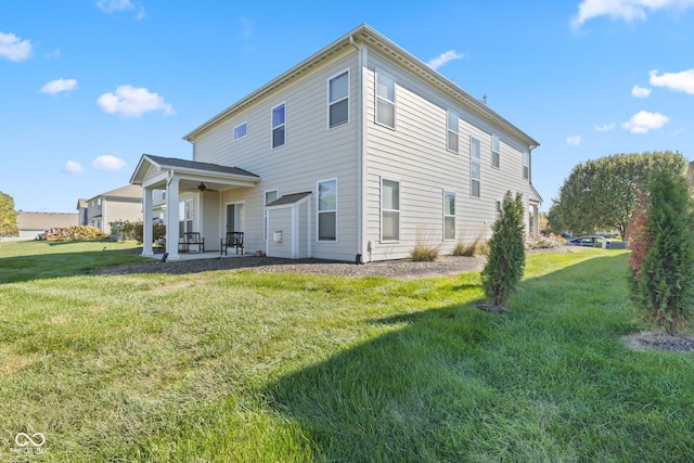 rear view of house with a yard and a patio area