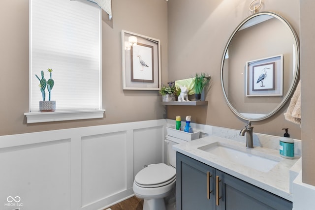 bathroom featuring vanity, hardwood / wood-style flooring, and toilet