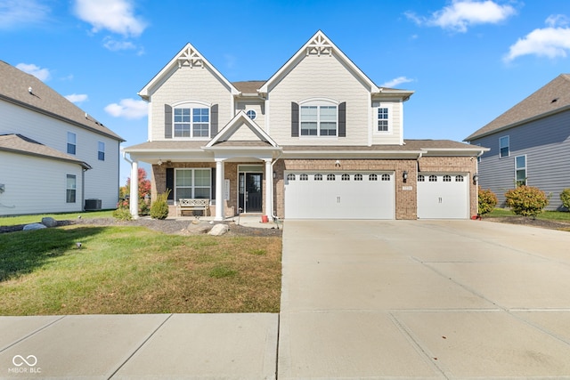 view of front of house with a front yard, a garage, central AC unit, and a porch