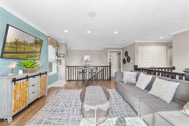 living room with light hardwood / wood-style floors and crown molding