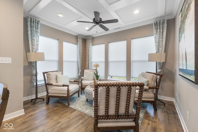 sitting room featuring a healthy amount of sunlight, coffered ceiling, dark wood-type flooring, and ceiling fan