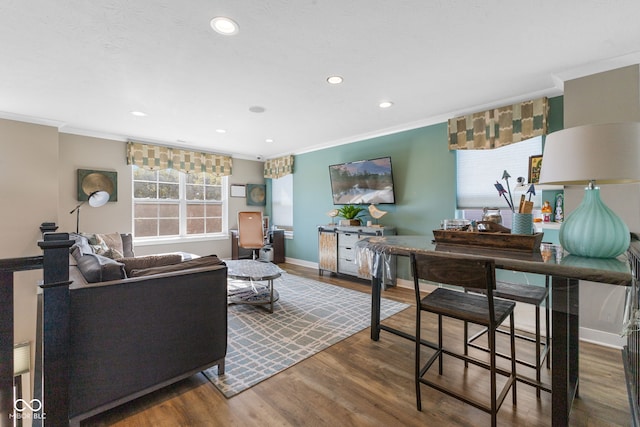 living room with crown molding and hardwood / wood-style floors