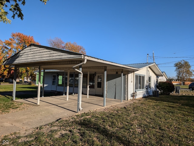 exterior space with a front yard and a patio area