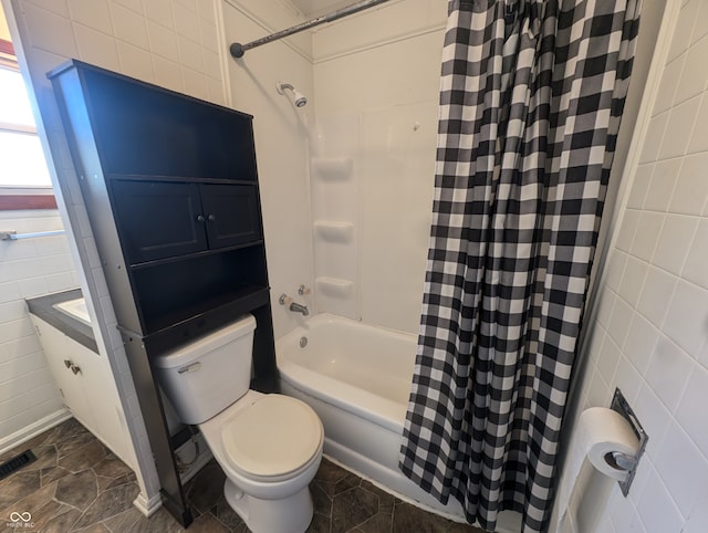 bathroom with toilet, shower / bathtub combination with curtain, and tile walls