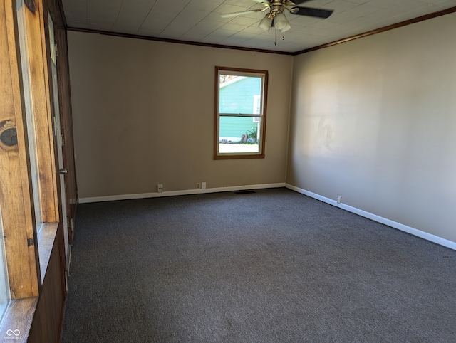 unfurnished room with ceiling fan, ornamental molding, and dark carpet