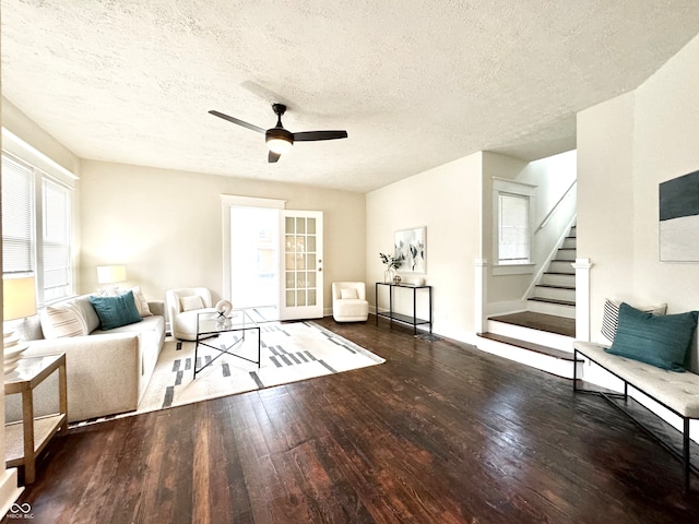 unfurnished living room featuring dark hardwood / wood-style floors, ceiling fan, a textured ceiling, and a wealth of natural light