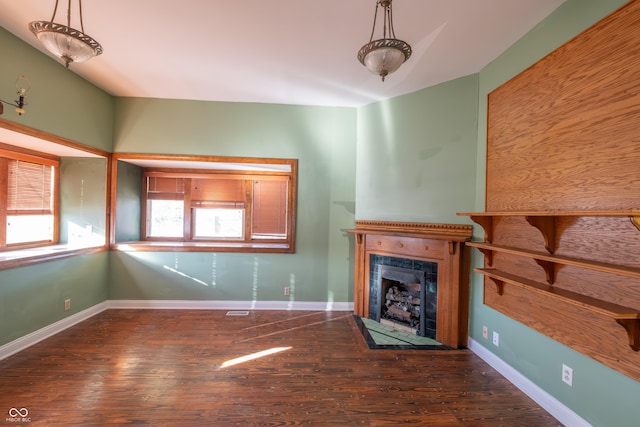 unfurnished living room with dark wood-type flooring