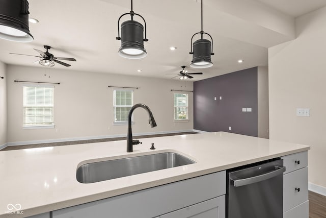 kitchen featuring pendant lighting, stainless steel dishwasher, a healthy amount of sunlight, and sink