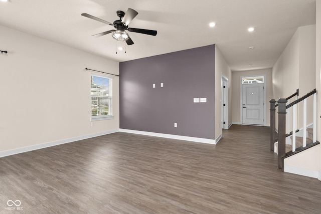 interior space featuring ceiling fan and dark wood-type flooring