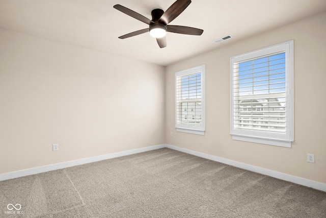 carpeted spare room featuring ceiling fan