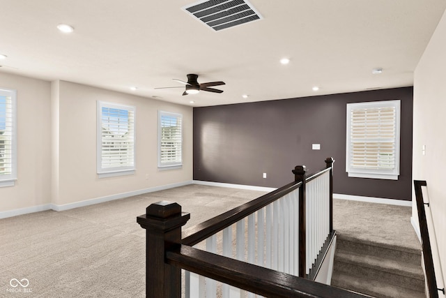 interior space with ceiling fan