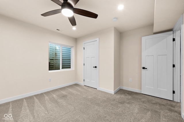 unfurnished bedroom with light carpet and ceiling fan