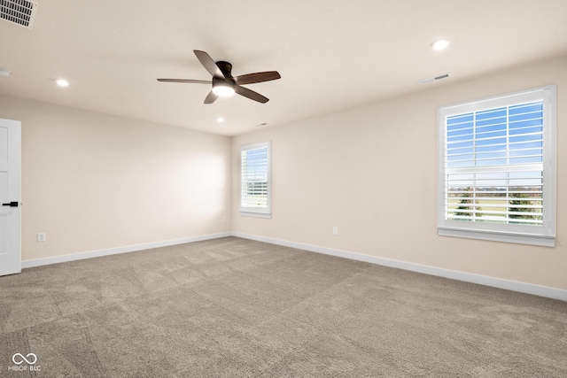 empty room with ceiling fan and light colored carpet