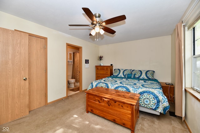 carpeted bedroom featuring a closet, ceiling fan, and ensuite bathroom