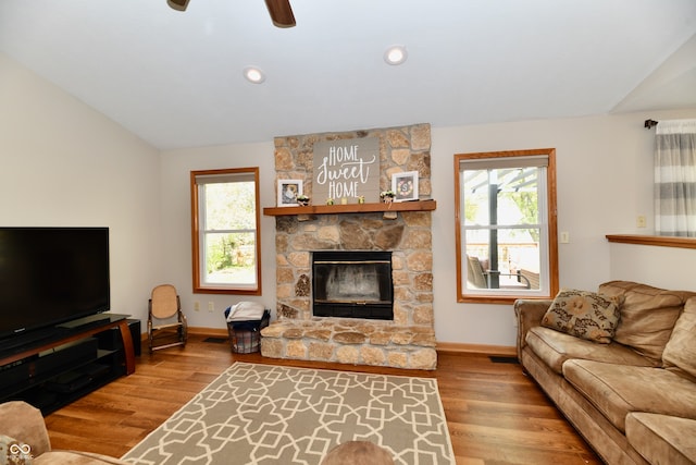 living room with lofted ceiling, hardwood / wood-style floors, and a healthy amount of sunlight