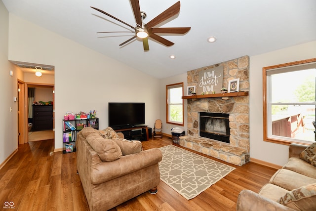 living room with lofted ceiling, a fireplace, wood-type flooring, and ceiling fan