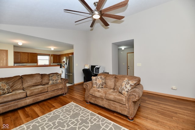 living room with lofted ceiling, hardwood / wood-style floors, and ceiling fan