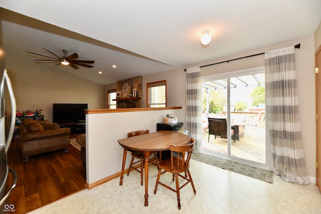 dining space with vaulted ceiling, hardwood / wood-style flooring, and ceiling fan