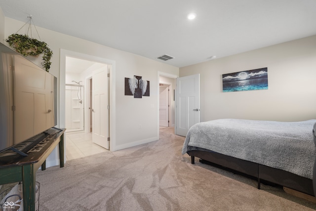 carpeted bedroom with ensuite bath