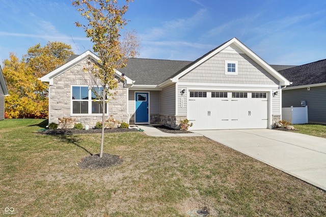 craftsman-style house featuring a garage and a front lawn