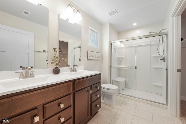 bathroom with vanity, an enclosed shower, and tile patterned flooring