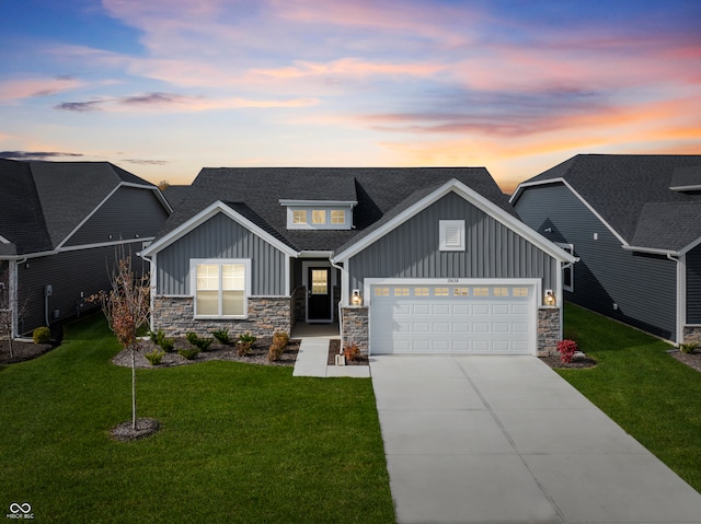 craftsman-style home with a yard and a garage