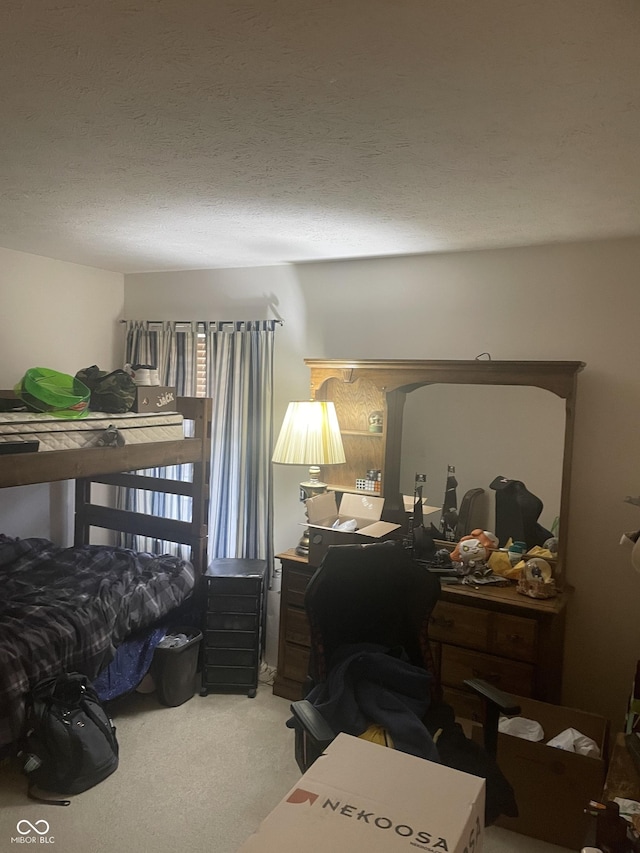 bedroom with carpet and a textured ceiling