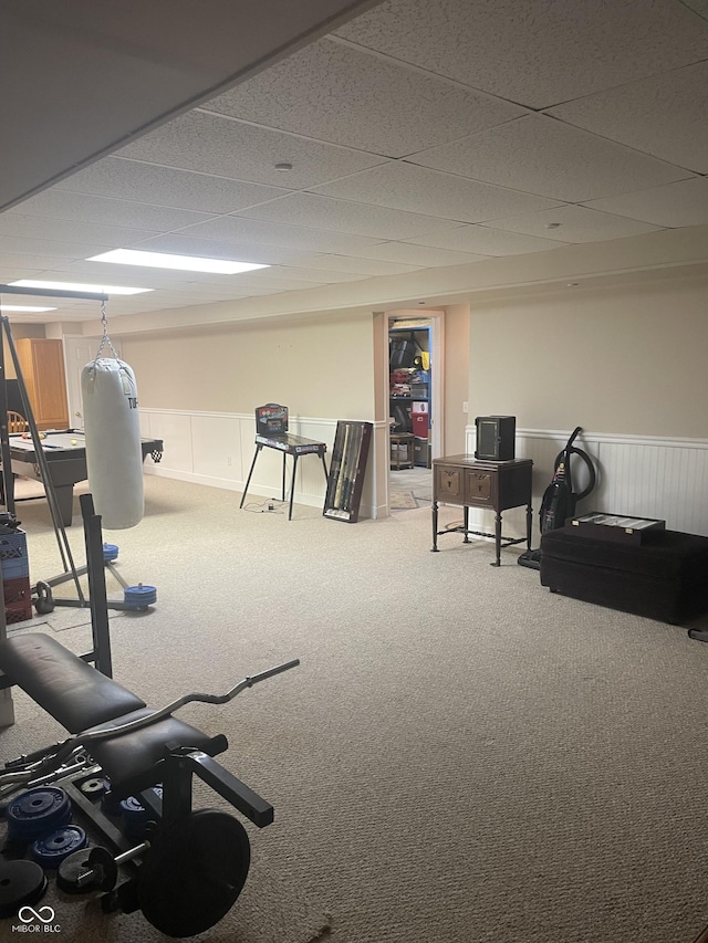 workout area featuring carpet floors and a drop ceiling