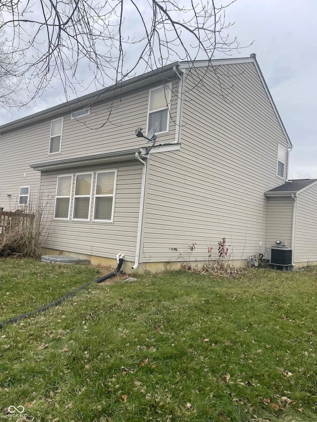 view of home's exterior featuring a yard and cooling unit