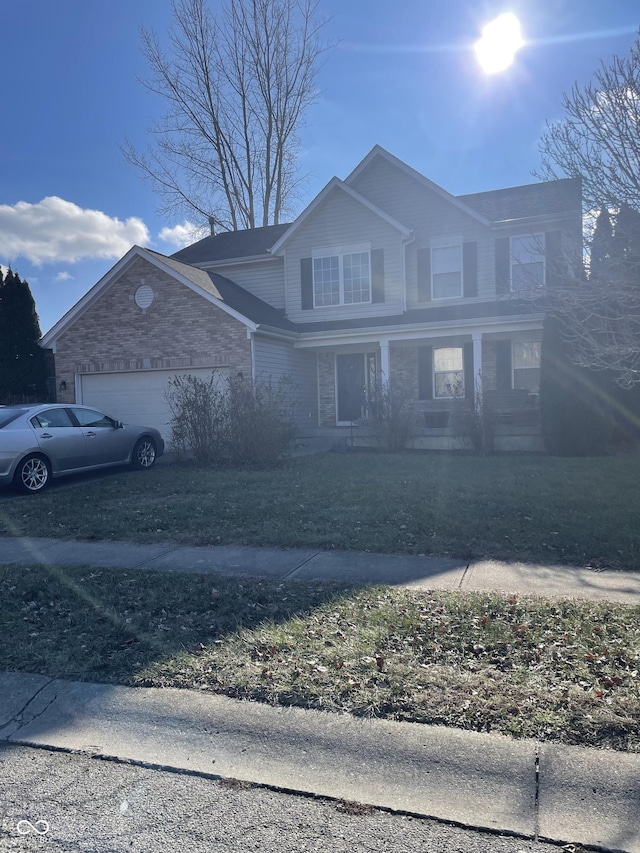 front of property featuring covered porch and a garage