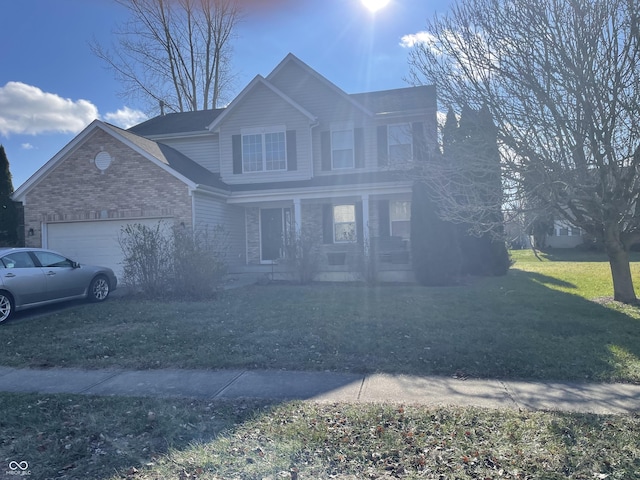 view of property featuring covered porch, a garage, and a front yard