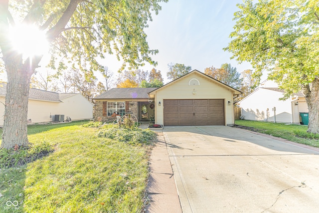 ranch-style house featuring central air condition unit, a front lawn, and a garage