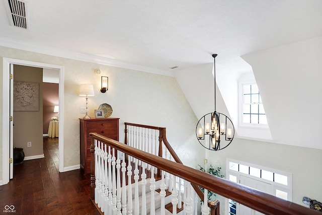 hall featuring lofted ceiling, dark wood-type flooring, and a chandelier