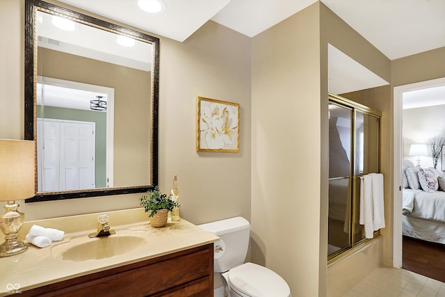 full bathroom featuring vanity, combined bath / shower with glass door, tile patterned floors, and toilet