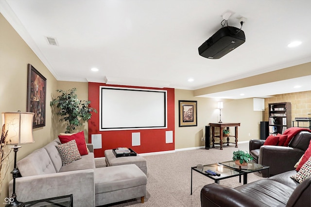 cinema room featuring ornamental molding and carpet floors