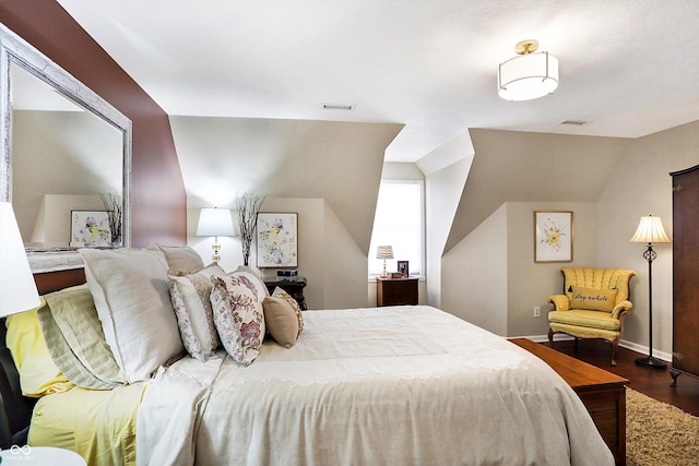 bedroom with dark hardwood / wood-style floors and vaulted ceiling