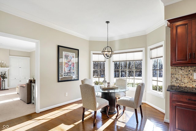 dining room with dark wood-type flooring, crown molding, and a notable chandelier