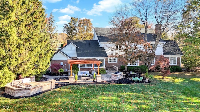 back of property featuring a yard, a patio area, and an outdoor living space with a fire pit