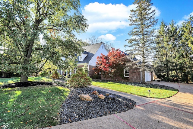 view of front of home featuring a garage and a front yard