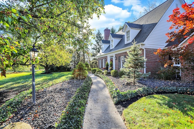 view of side of property with a yard