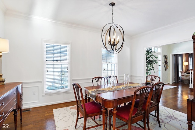 dining area with ornamental molding, dark hardwood / wood-style floors, and a chandelier