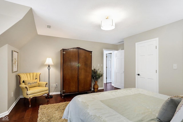 bedroom with lofted ceiling and dark hardwood / wood-style floors