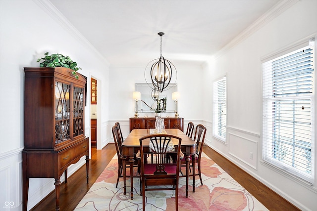 dining room featuring hardwood / wood-style flooring, ornamental molding, and plenty of natural light