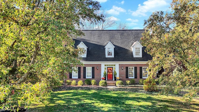 cape cod-style house with a front lawn