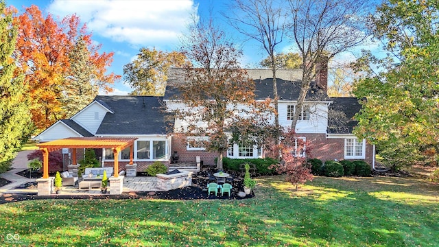 back of house with outdoor lounge area, a lawn, and a patio area