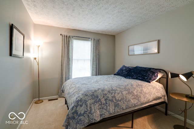 carpeted bedroom featuring a textured ceiling