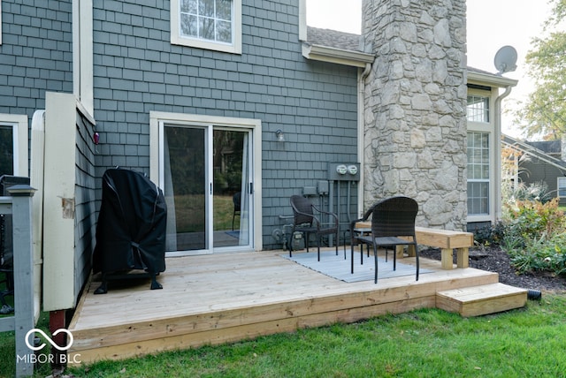 rear view of house featuring a wooden deck