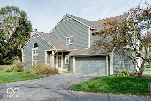 view of front property with a front yard and a garage