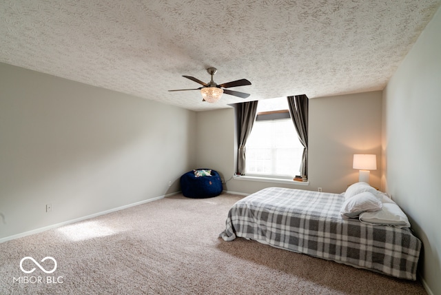 unfurnished bedroom with a textured ceiling, carpet flooring, and ceiling fan